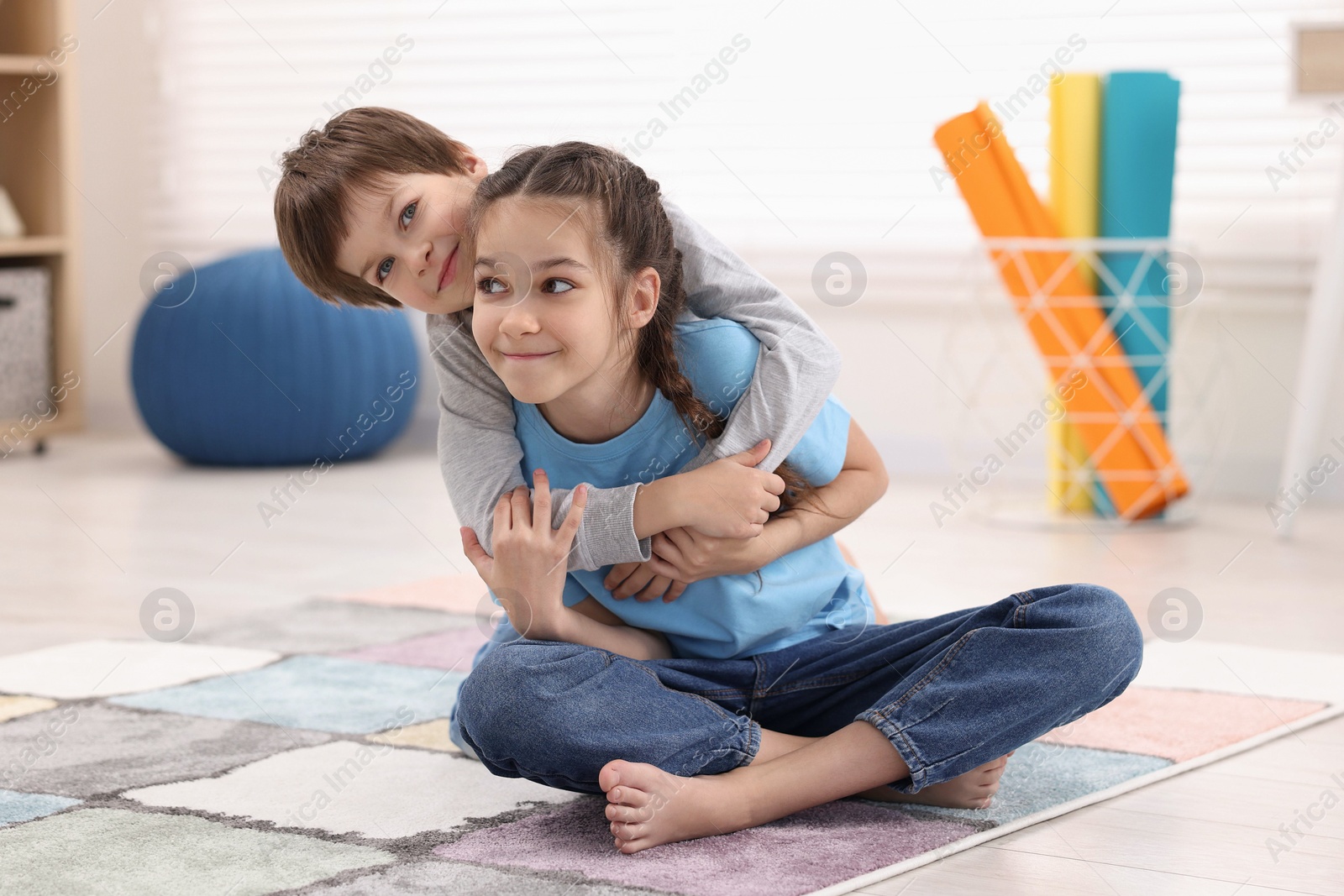 Photo of Happy brother and sister spending time together at home