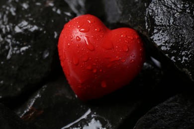 Red decorative heart on stones, closeup view