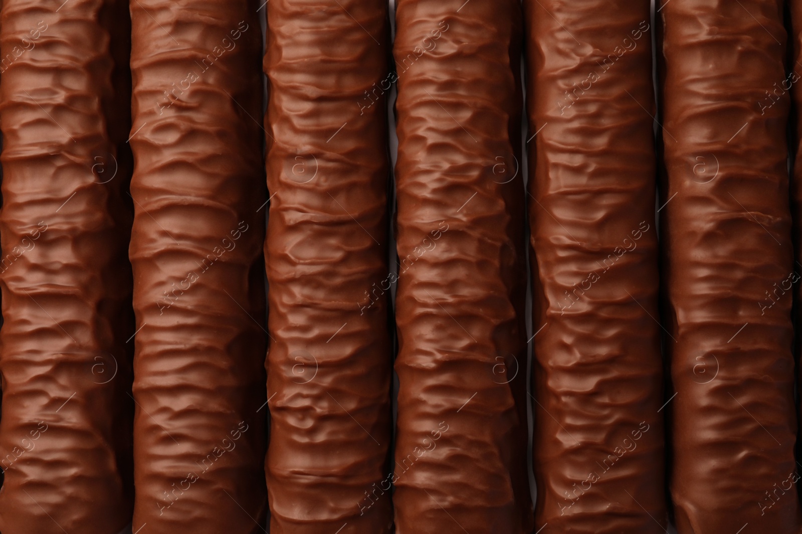 Photo of Sweet tasty chocolate bars as background, top view