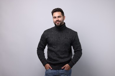 Happy man in stylish sweater on white background