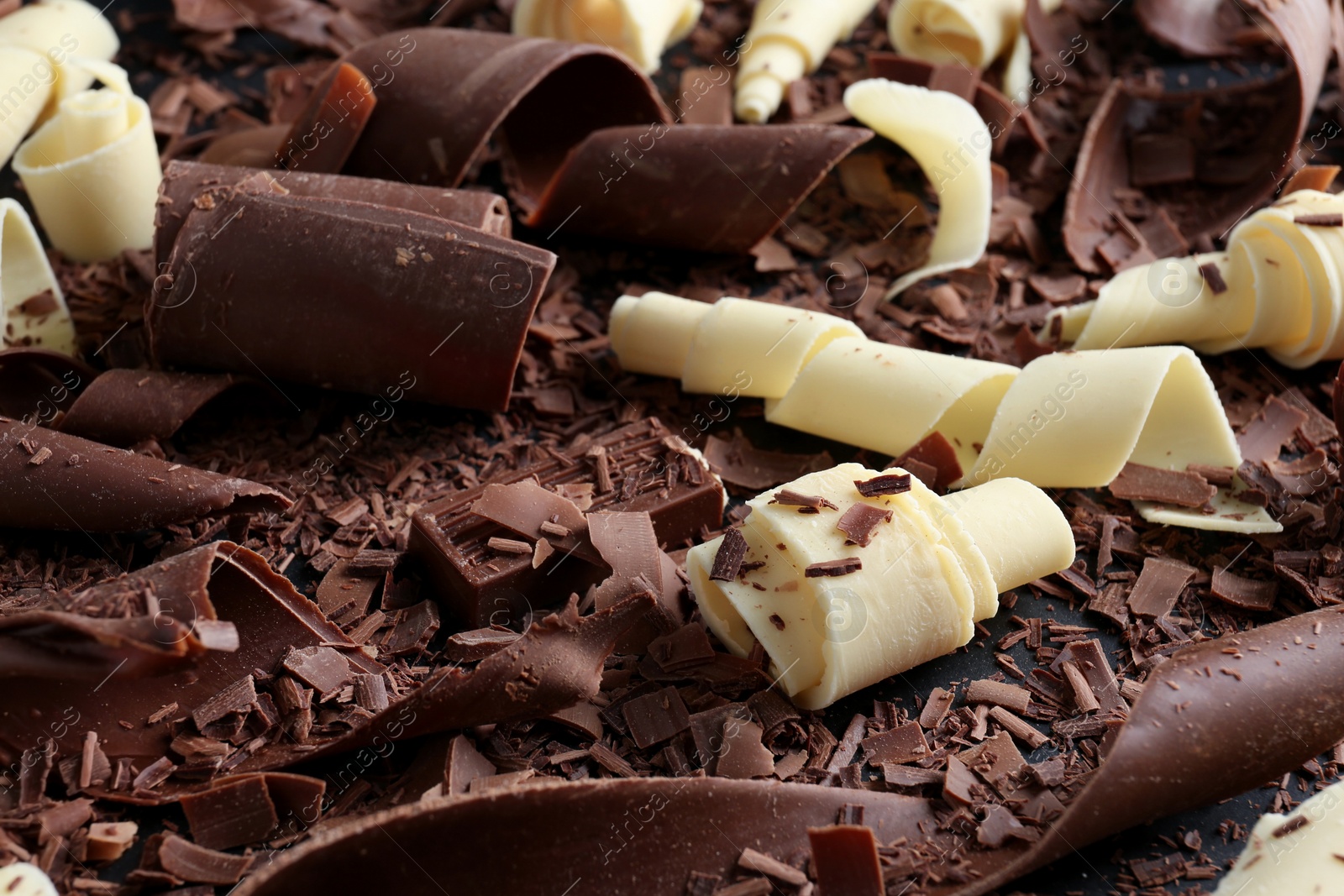 Photo of Yummy chocolate curls for decor as background, closeup