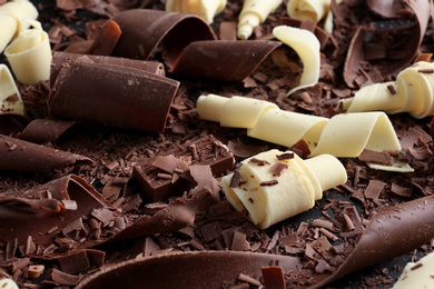 Photo of Yummy chocolate curls for decor as background, closeup
