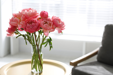 Photo of Beautiful bouquet of fragrant peonies in vase on table indoors. Space for text