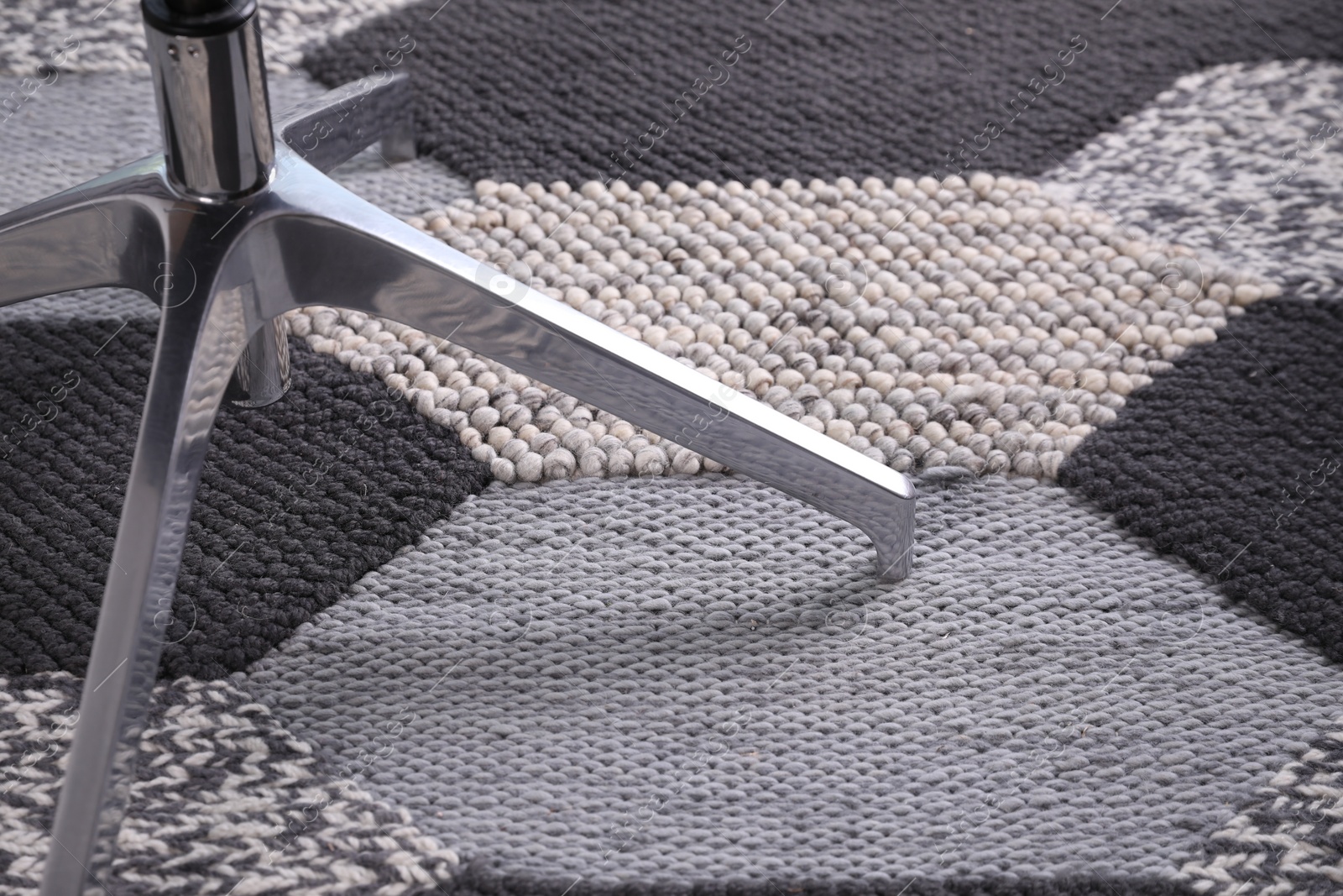 Photo of Modern office chair on carpet, closeup view