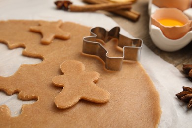 Photo of Dough and cookie cutter on table, closeup
