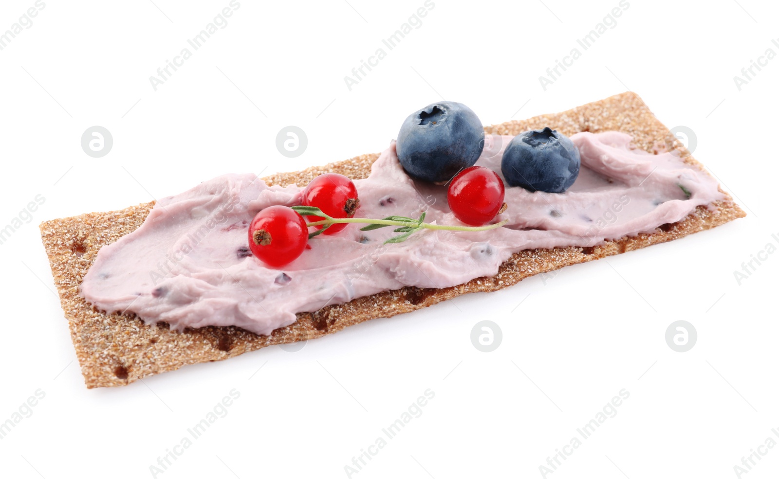 Photo of Tasty cracker sandwich with cream cheese, blueberries, red currants and thyme isolated on white