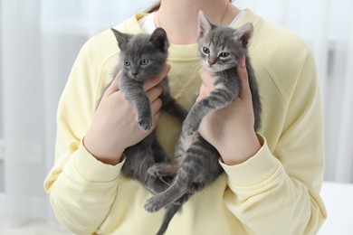 Woman with cute fluffy kittens at home, closeup
