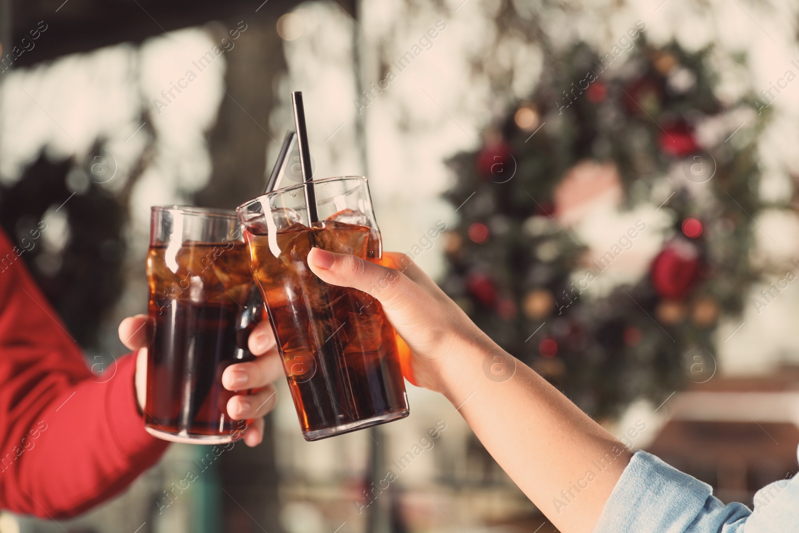 Photo of Young couple with glasses of cola indoors, closeup