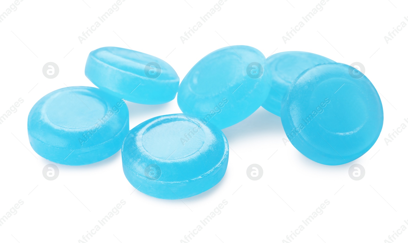 Photo of Many light blue cough drops on white background