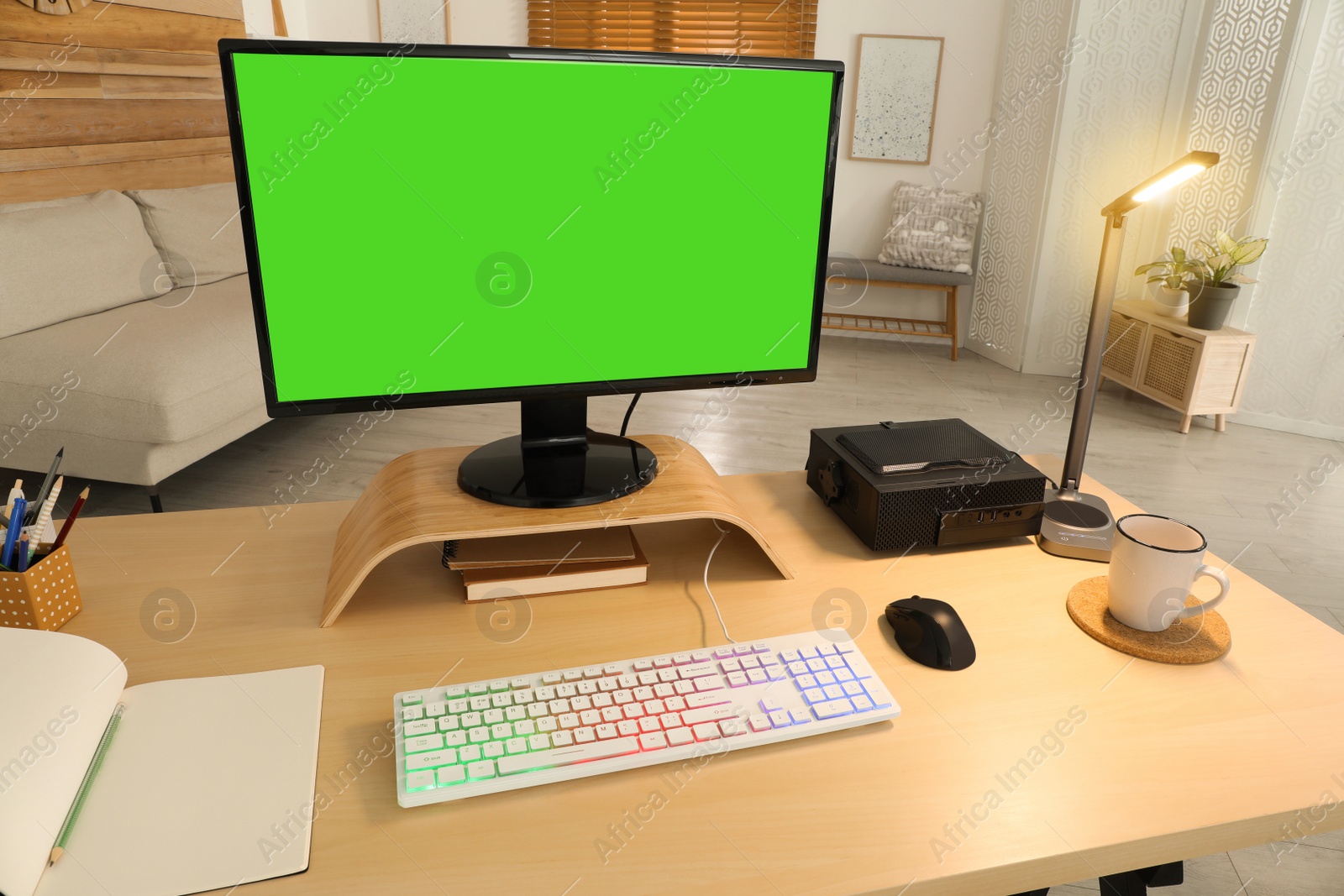 Photo of Modern computer and RGB keyboard on wooden table indoors. Mockup green screen