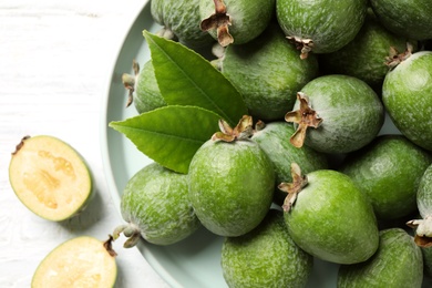 Photo of Flat lay composition with fresh green feijoa fruits on white wooden table
