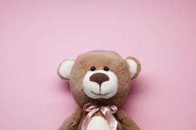 Photo of Cute teddy bear on pink background, top view