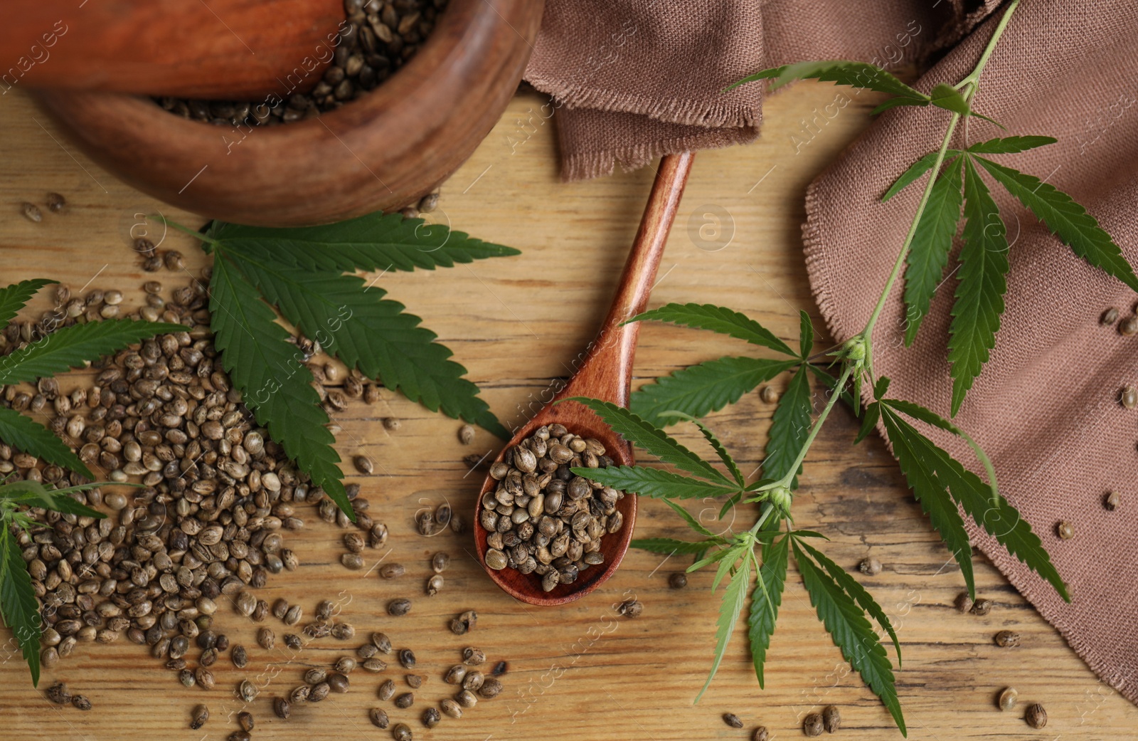 Photo of Flat lay composition with hemp seeds and leaves on wooden table