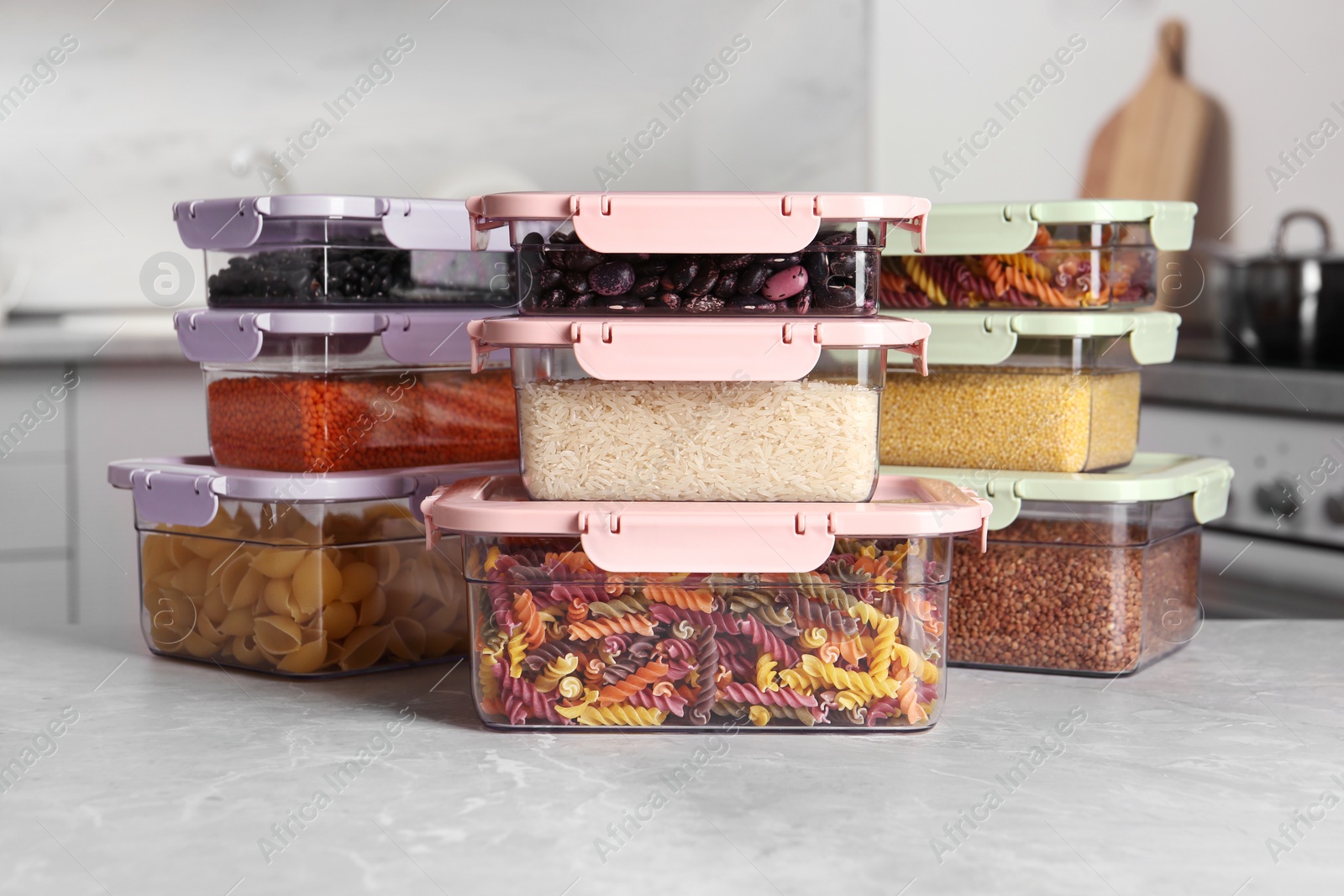 Photo of Many boxes with different food on table in kitchen