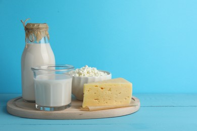Photo of Lactose free dairy products on light blue wooden table, space for text
