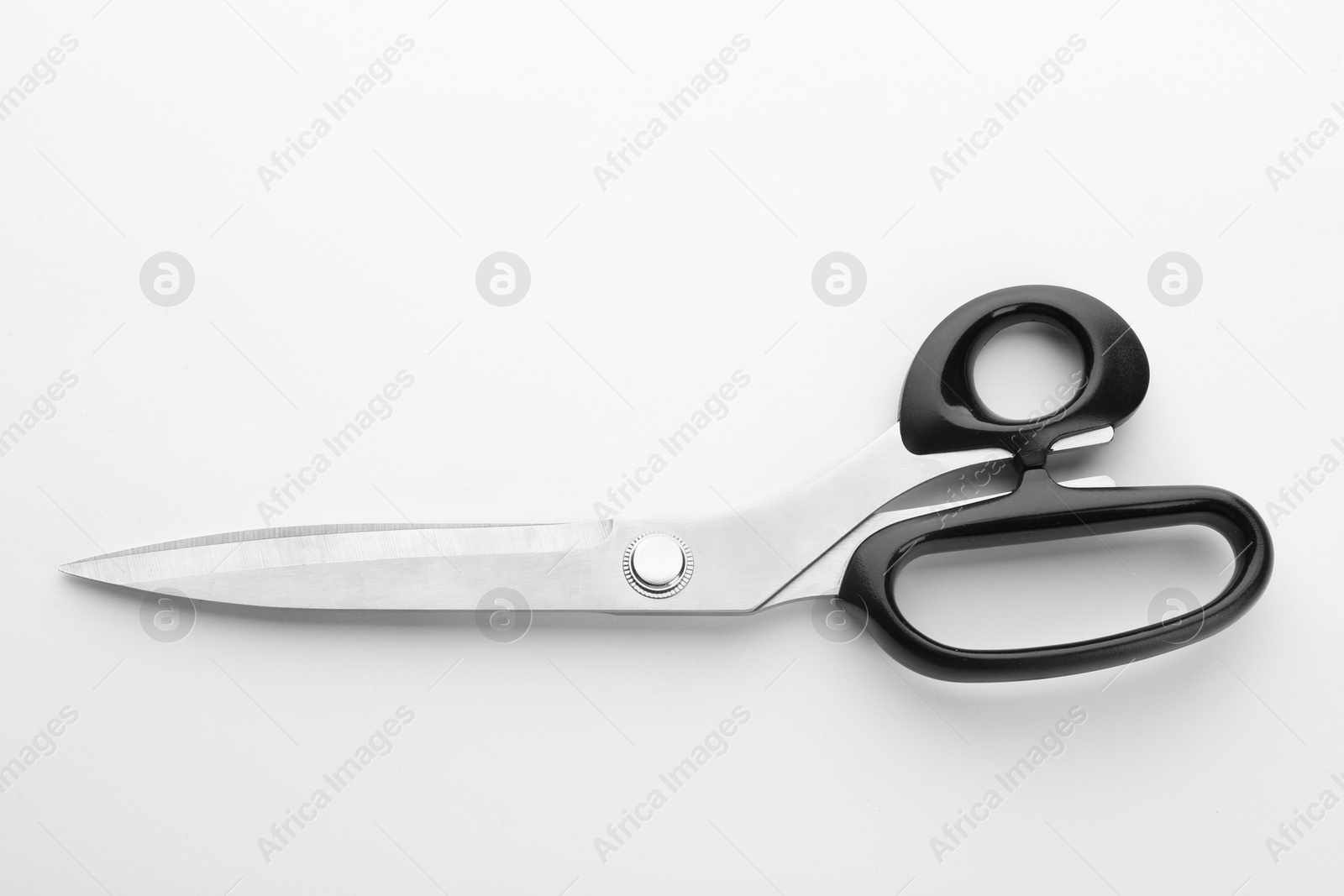 Photo of Pair of sharp sewing scissors on white background