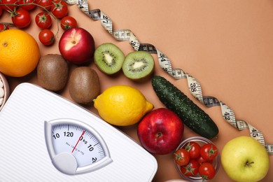 Photo of Scales, measuring tape, fresh fruits and vegetables on light brown background, flat lay with space for text. Low glycemic index diet