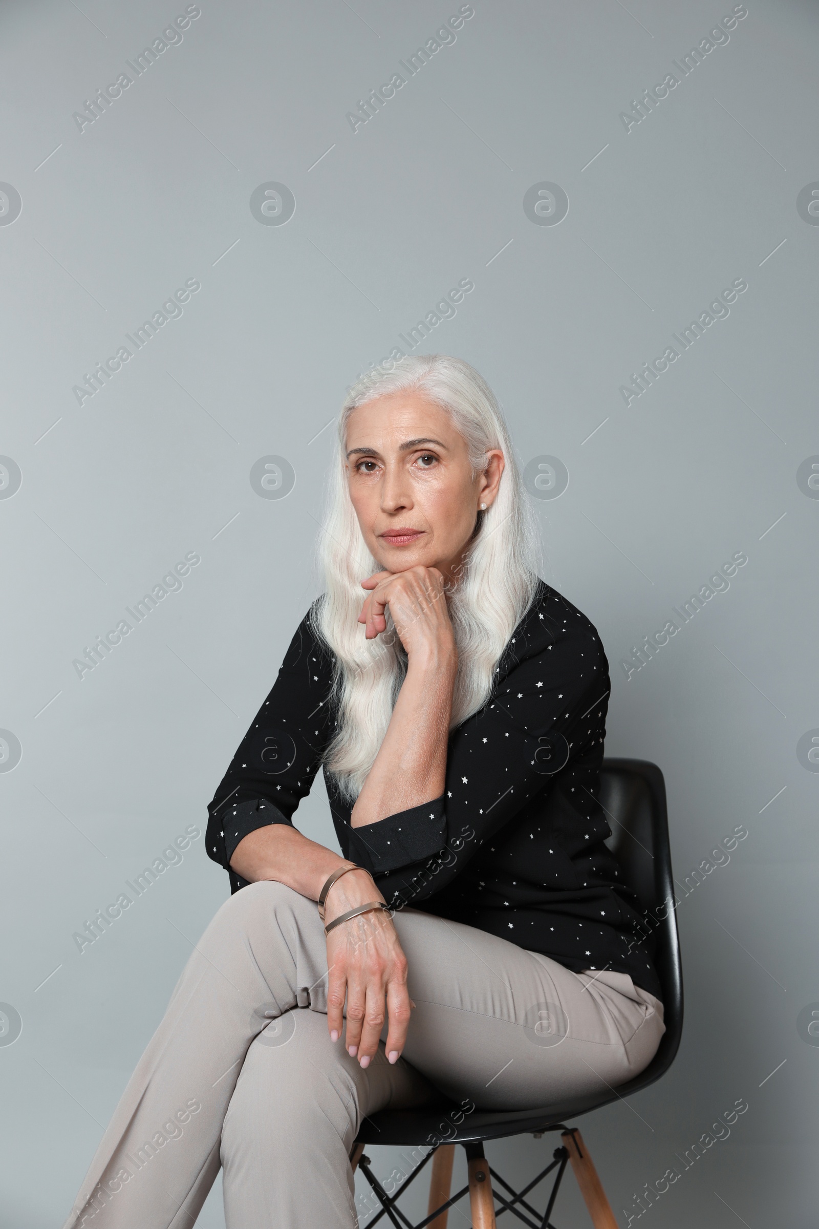 Photo of Portrait of beautiful mature woman on grey background