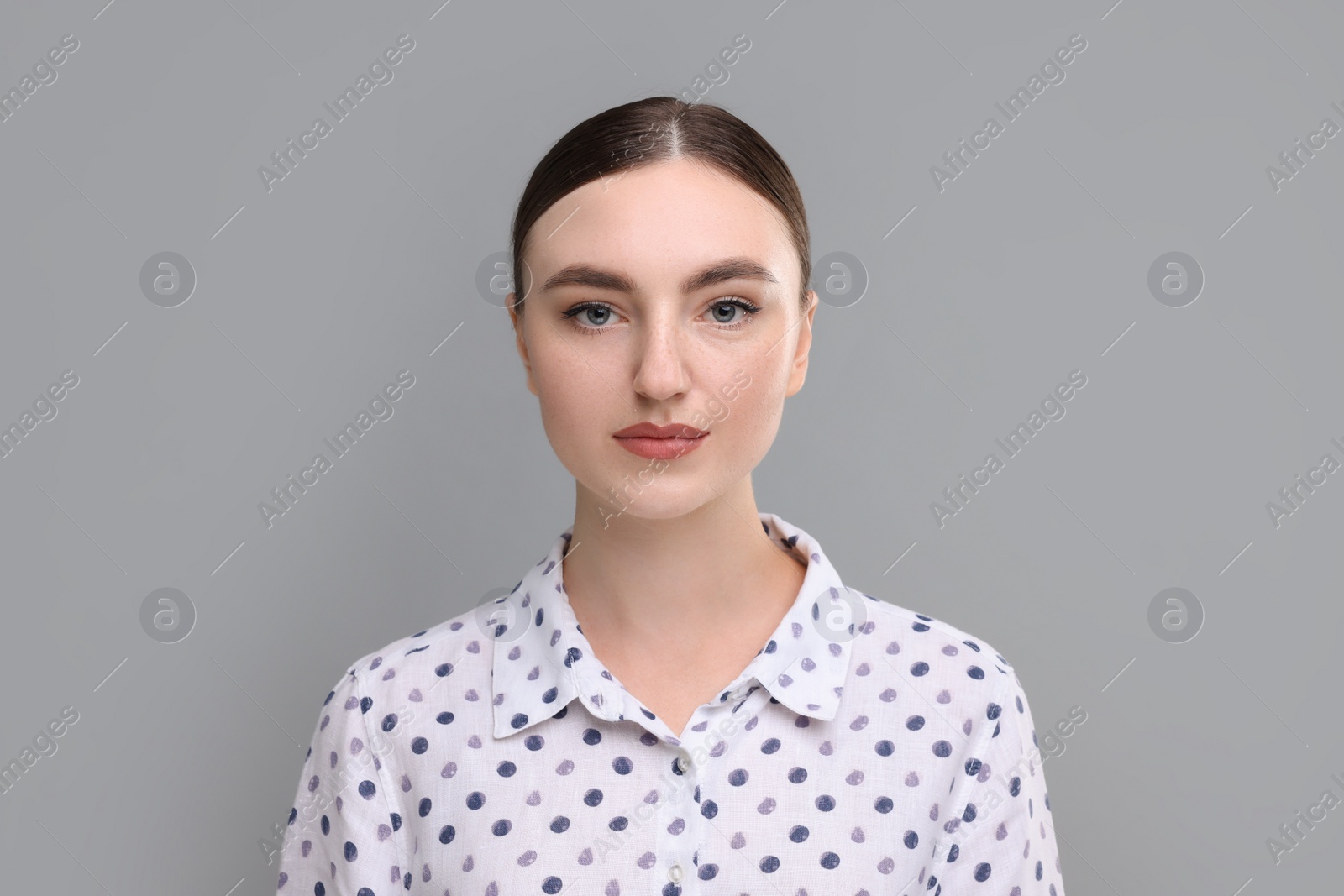 Photo of Portrait of beautiful woman on grey background