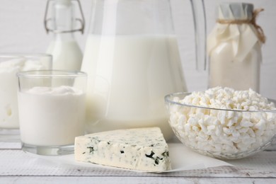 Photo of Different fresh dairy products on white wooden table