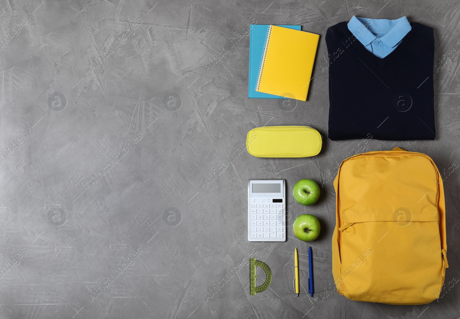 Photo of Flat lay composition with school uniform on grey background. Space for text