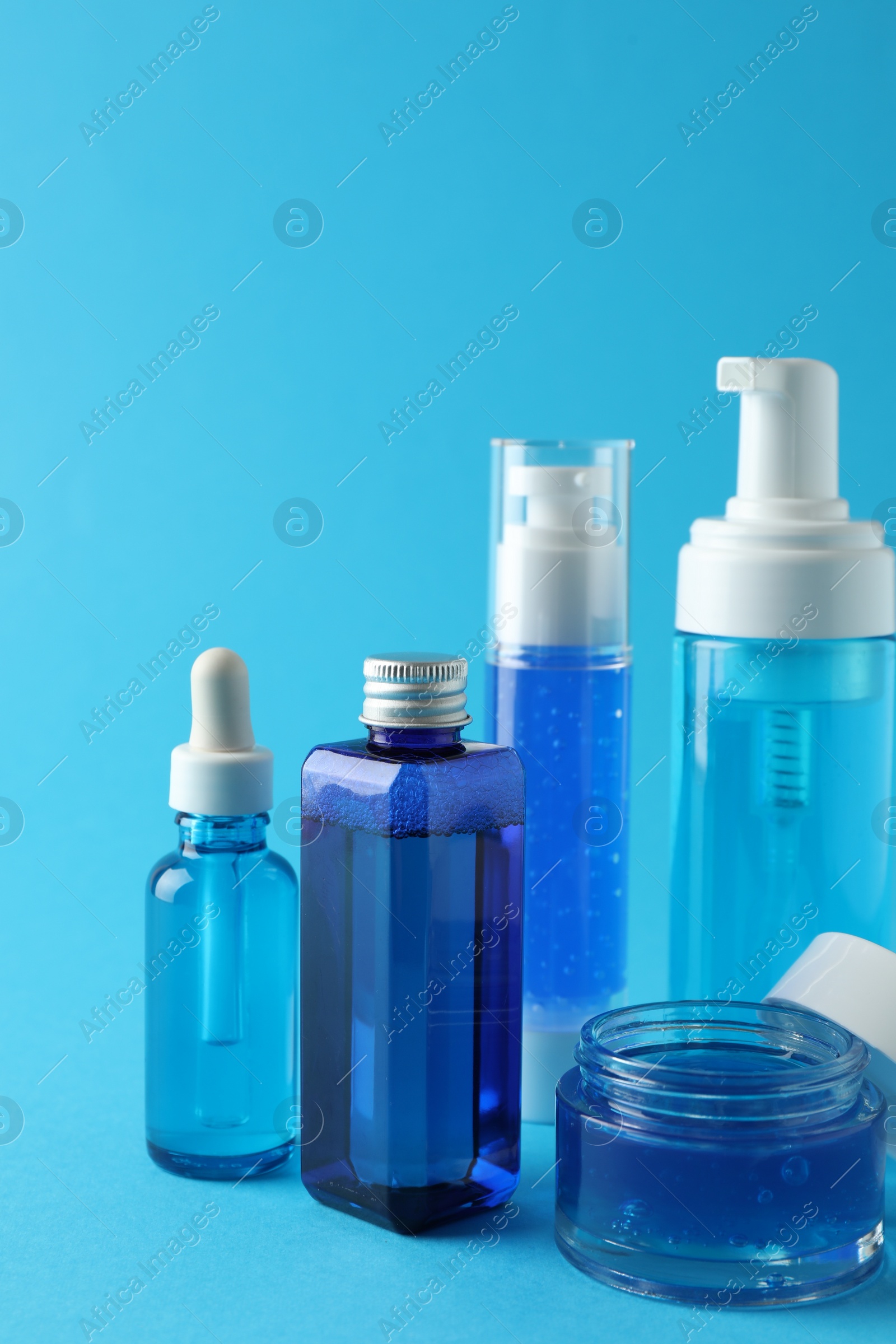 Photo of Set of luxury cosmetic products on light blue background