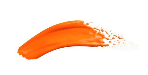 Photo of Abstract brushstroke of orange paint isolated on white