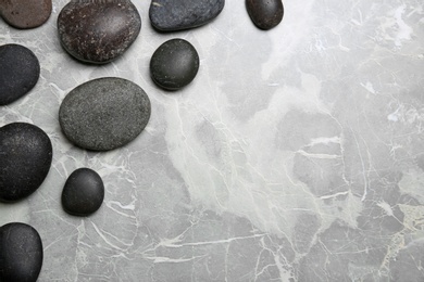 Photo of Spa stones on grey background, top view. Space for text