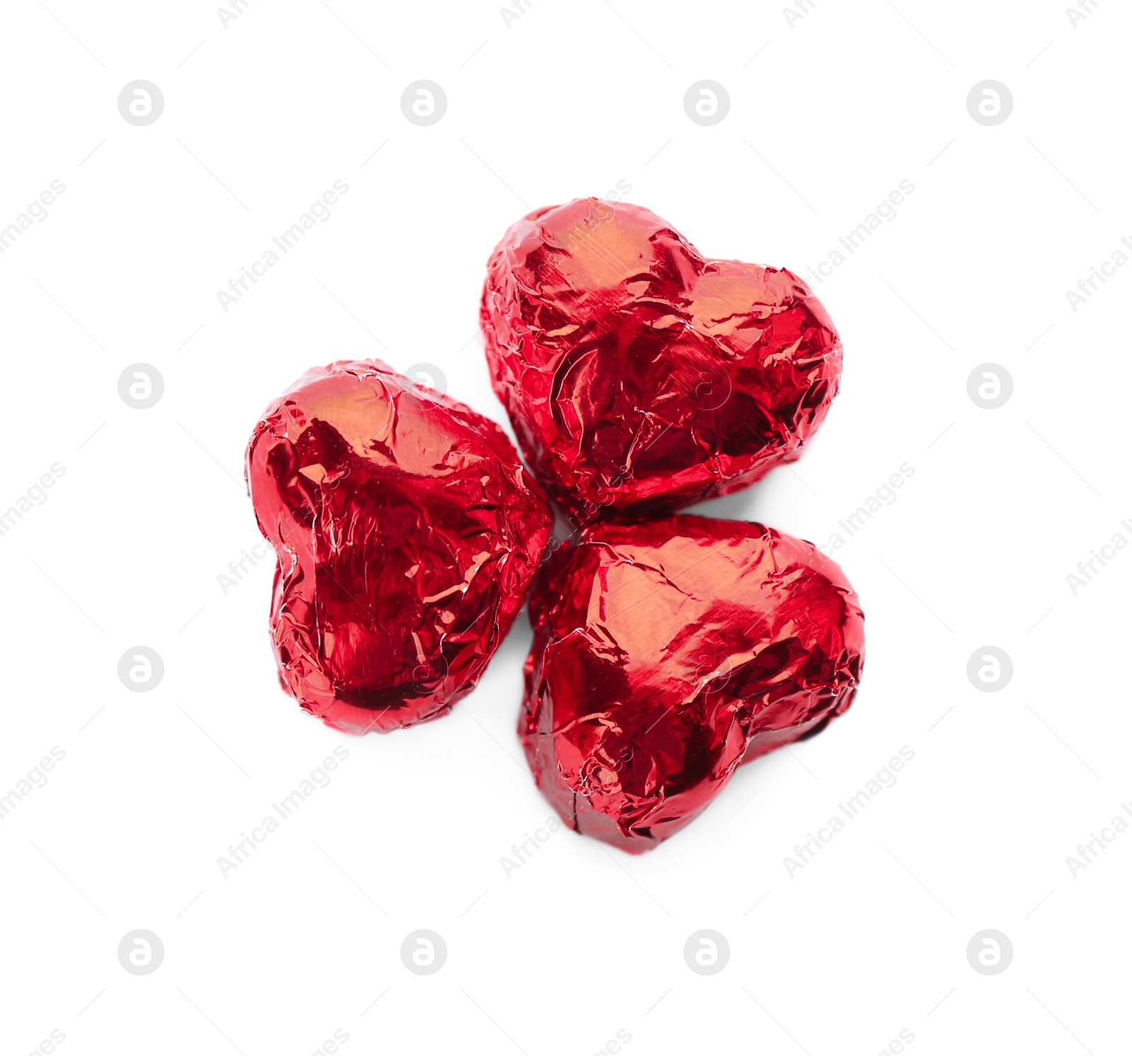 Photo of Heart shaped chocolate candies in red foil on white background, top view