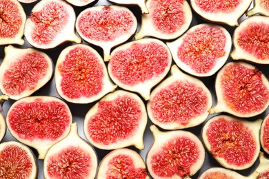 Photo of Cut ripe figs as background, top view