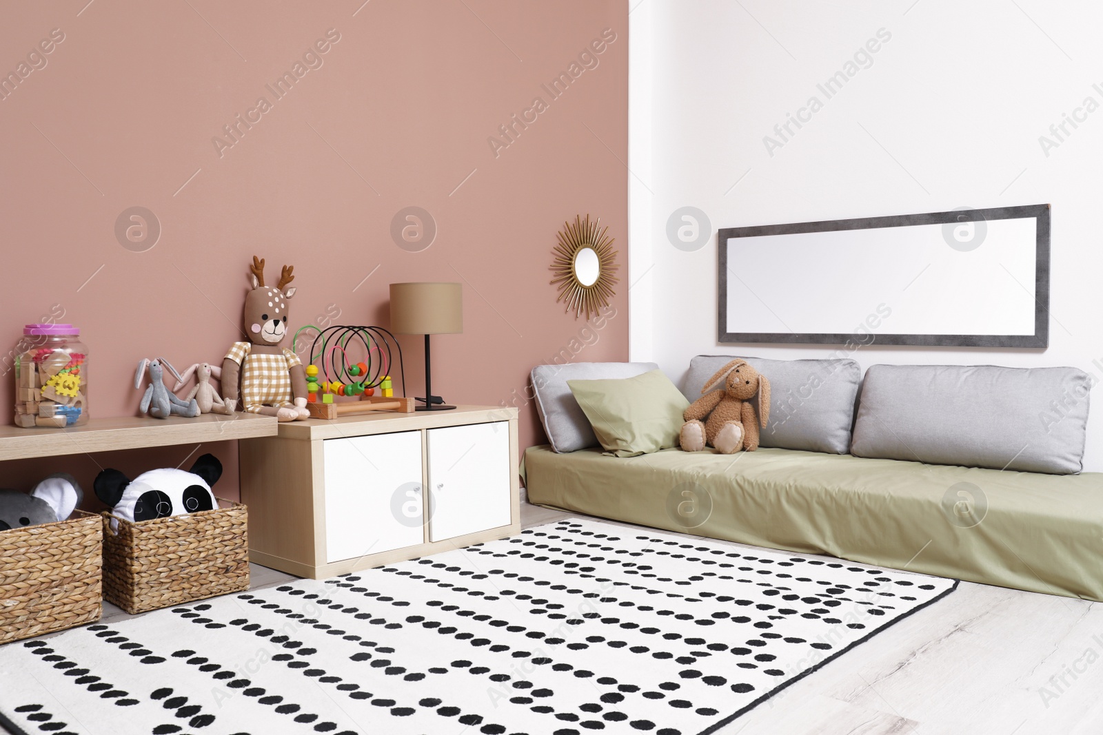 Photo of Montessori bedroom interior with floor bed and toys