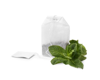 Photo of New tea bag with label and mint on white background