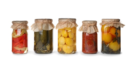 Photo of Different jars with pickled vegetables on white background