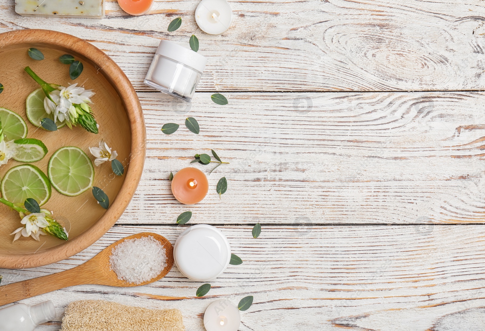 Photo of Composition with spa accessories and flowers on wooden background