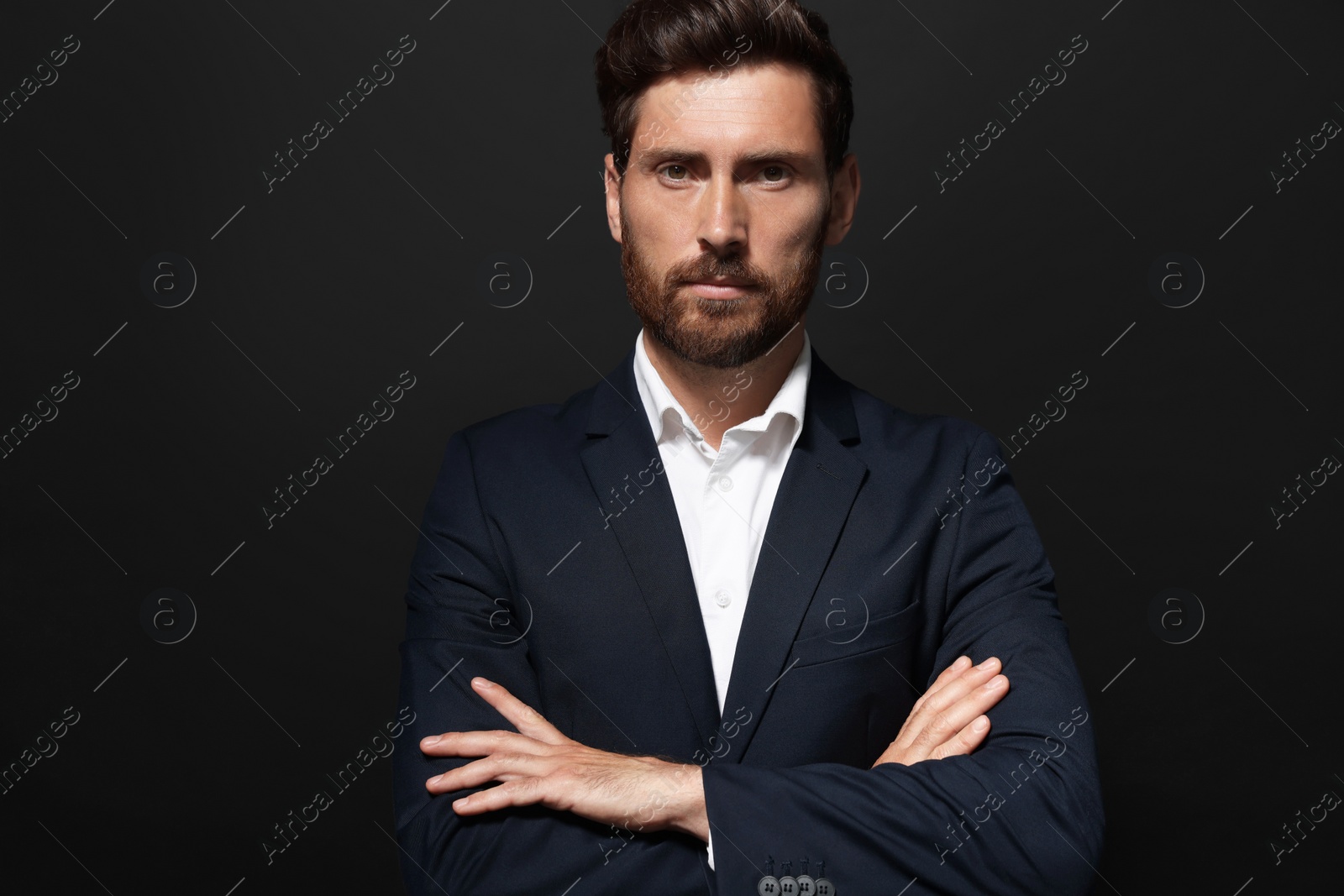 Photo of Portrait of handsome bearded man on black background. Space for text