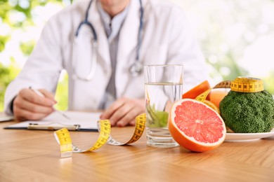 Image of Healthy products, measuring tape and blurred view of nutritionist outdoors