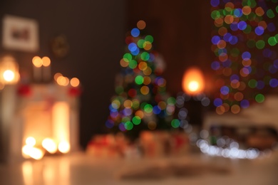 Photo of Blurred view of stylish living room interior with decorated Christmas tree at night