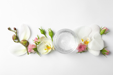 Composition with cosmetic gel and beautiful flowers on white background, top view