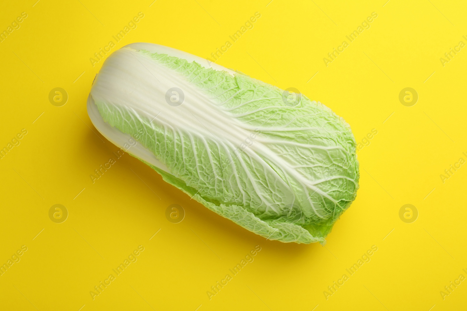 Photo of Fresh ripe Chinese cabbage on yellow background, top view