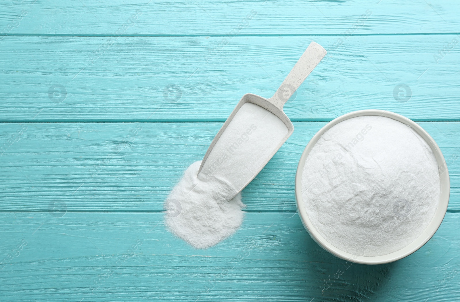 Photo of Baking soda on blue wooden table, flat lay