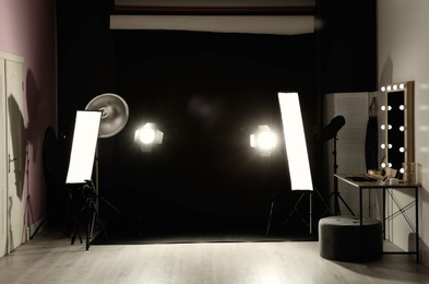 Interior of modern photo studio with dressing table and professional lighting equipment