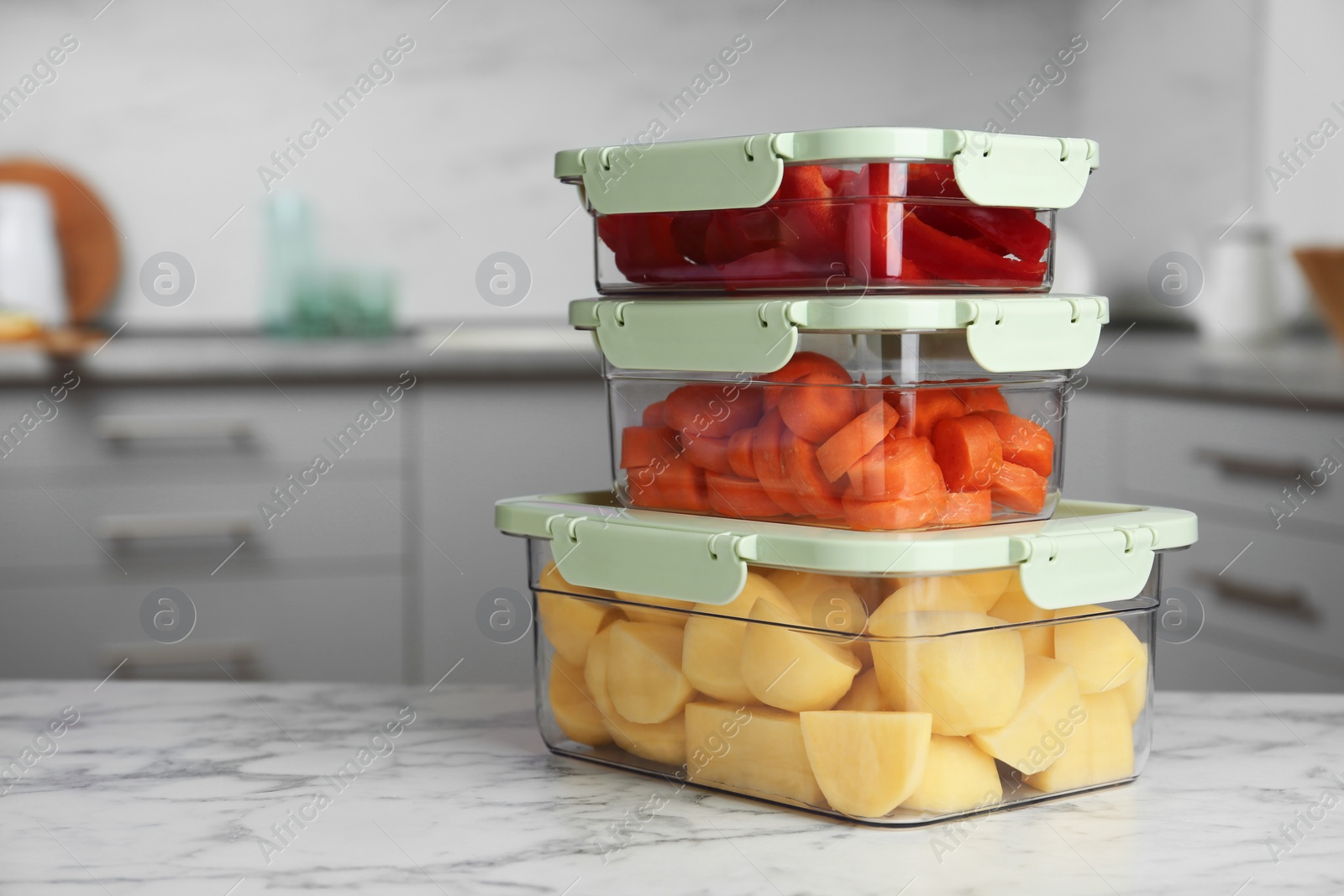 Photo of Boxes with fresh raw vegetables on table in kitchen, space for text