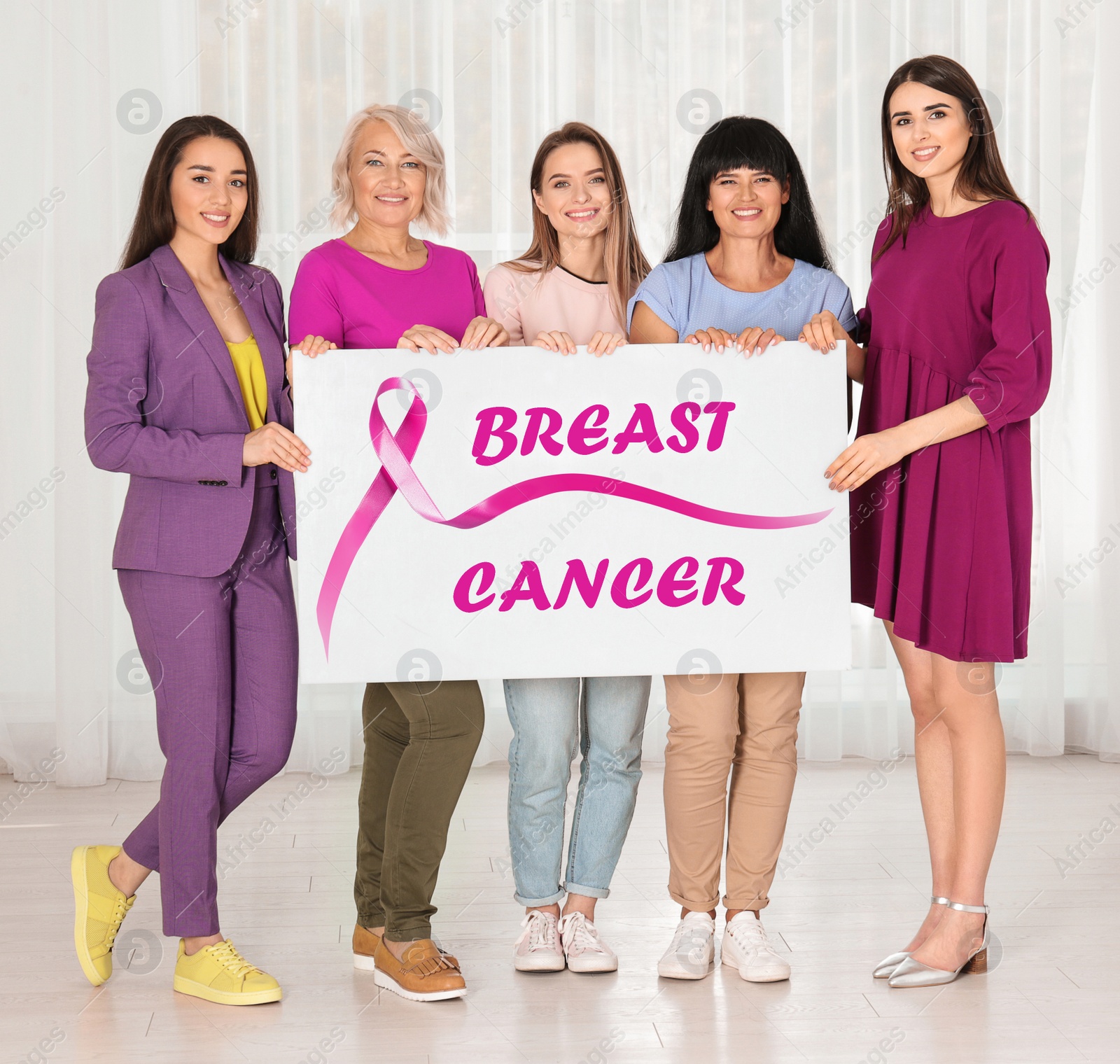 Image of Group of women holding poster with text BREAST CANCER indoors