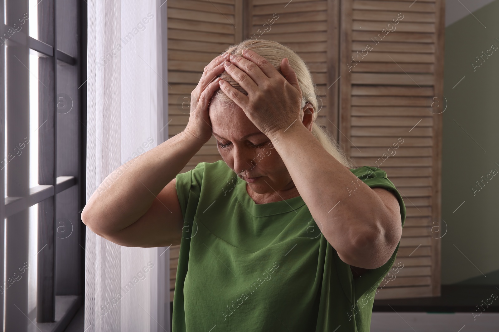 Photo of Mature woman suffering from depression at home