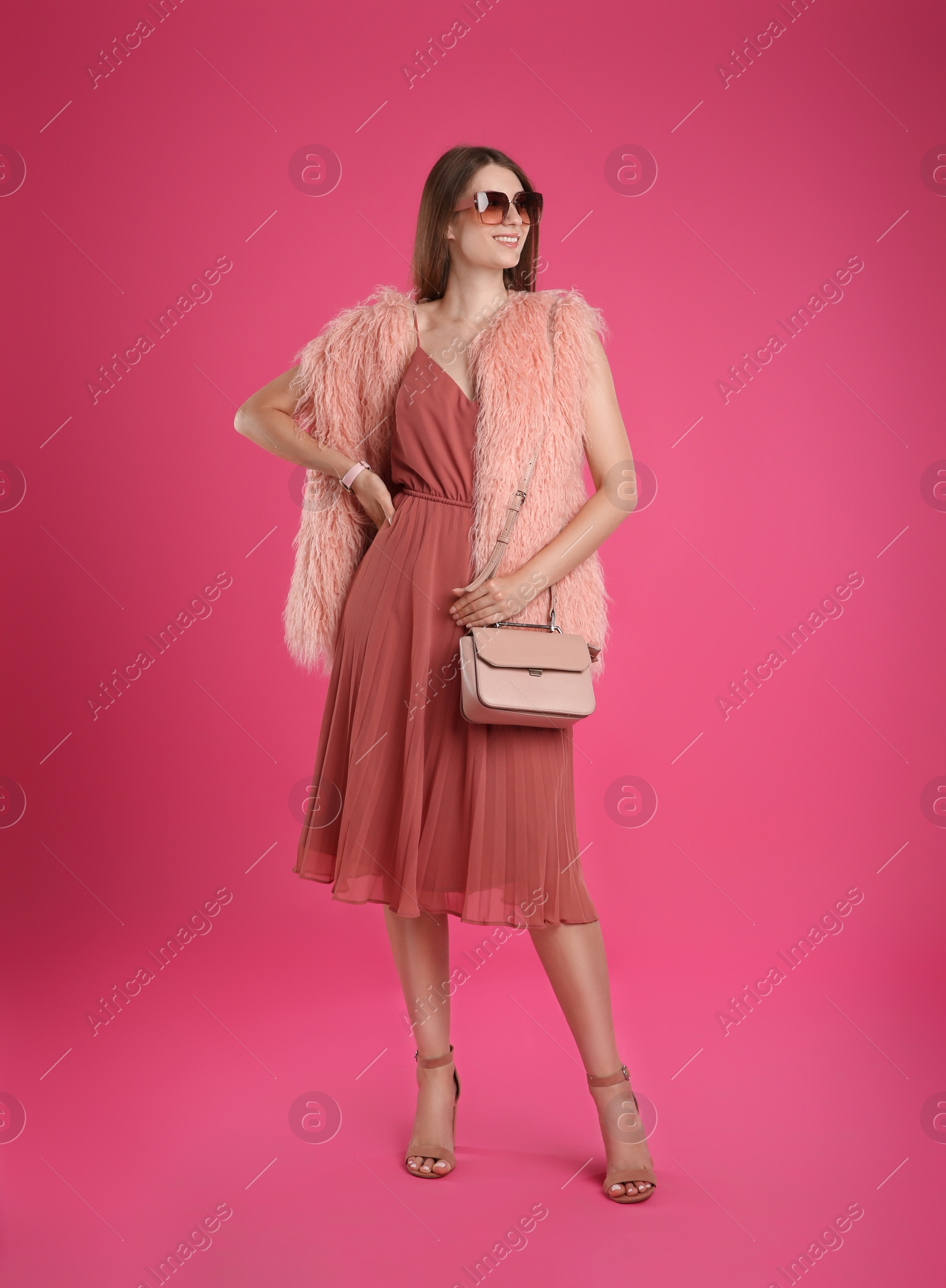 Photo of Beautiful young woman with stylish bag on pink background