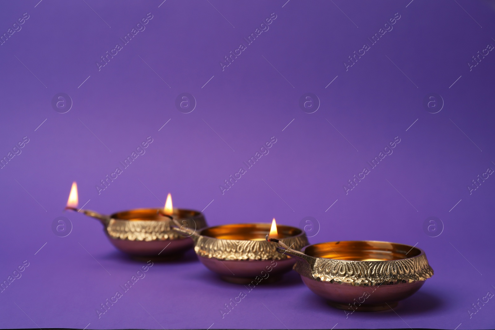 Photo of Diwali diyas or clay lamps on color background