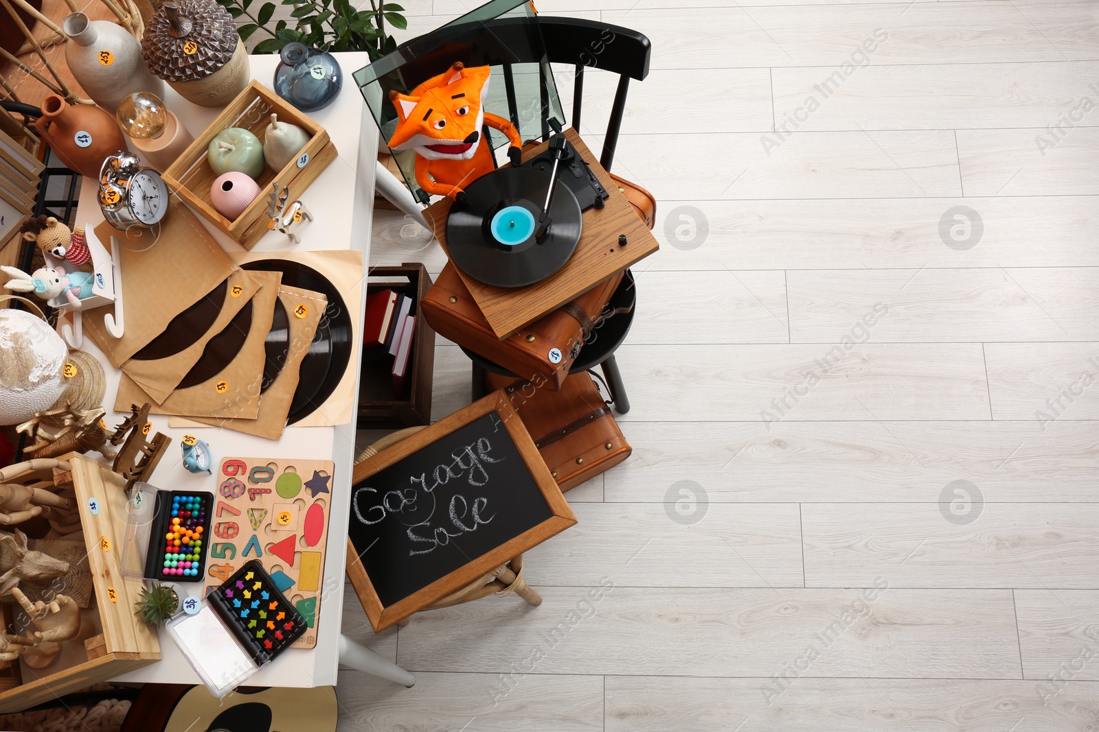 Photo of Sign Garage Sale written on blackboard near many different stuff indoors, above view with space for text