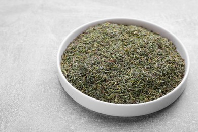 Photo of Plate with dried thyme on grey table, closeup