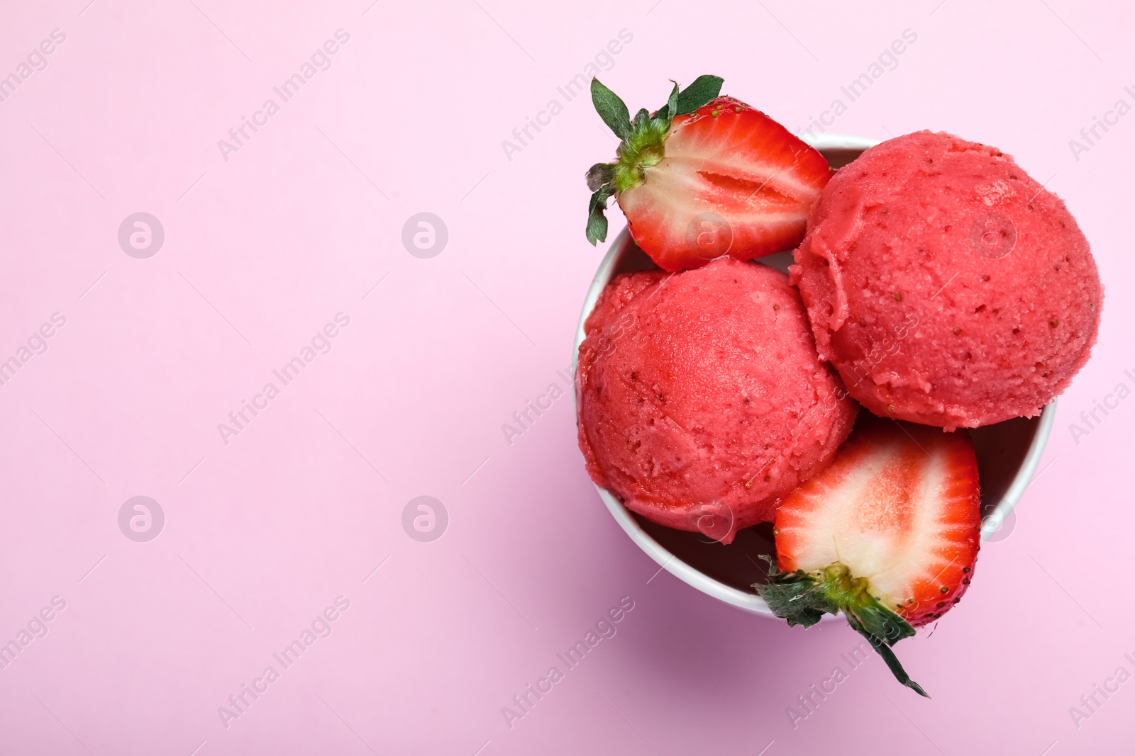 Photo of Delicious strawberry ice cream on pink background, top view. Space for text