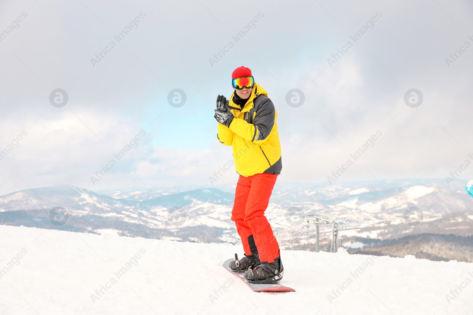 Photo of Male snowboarder on snowy hill. Winter vacation